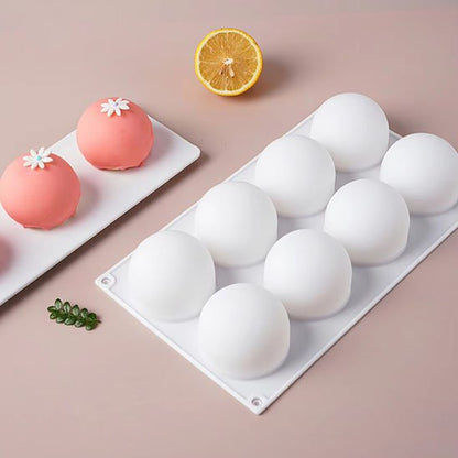 Moule à gâteau en silicone blanc avec 2demi sphère rose et une orange